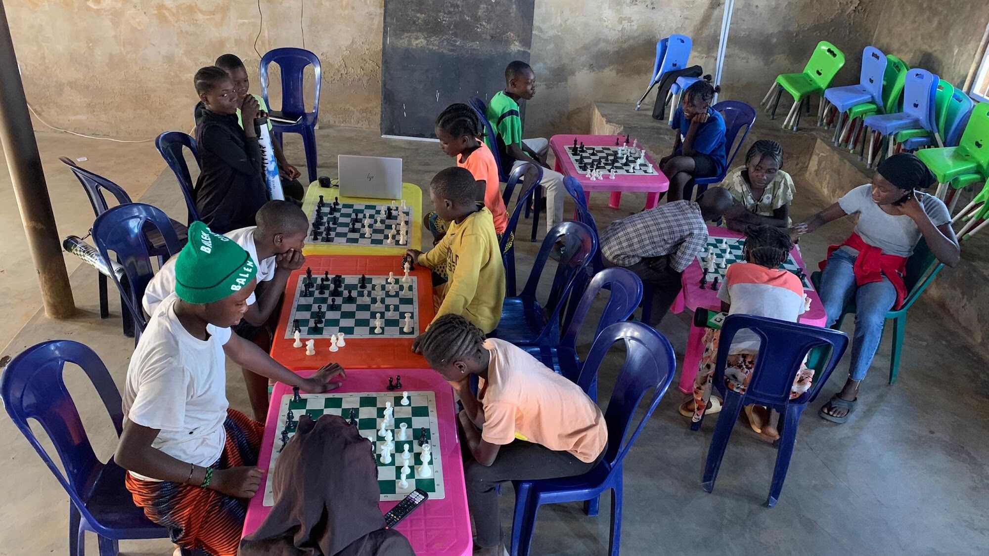 Learners playing chess in a community class