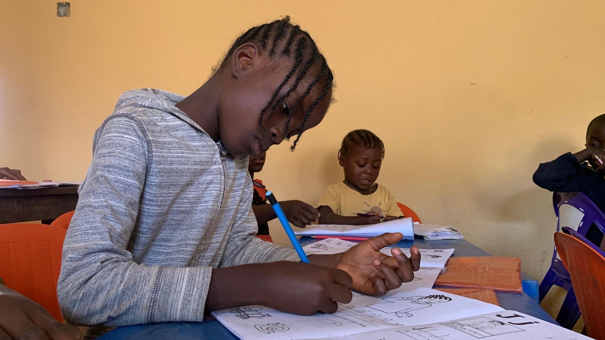 A learner writing in her exercise book