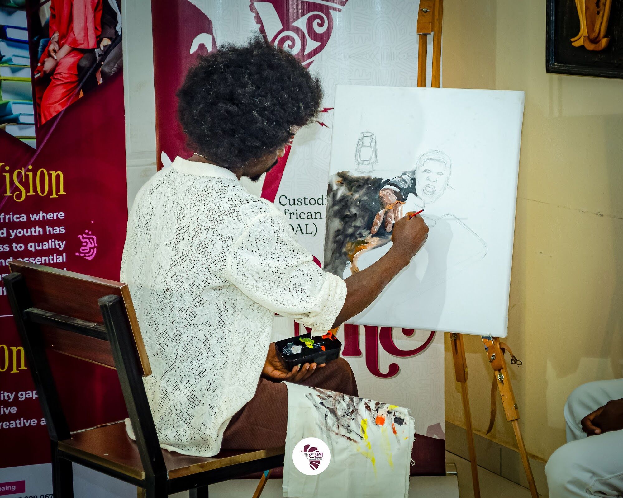 An artist painting live at a COAL Open Mic